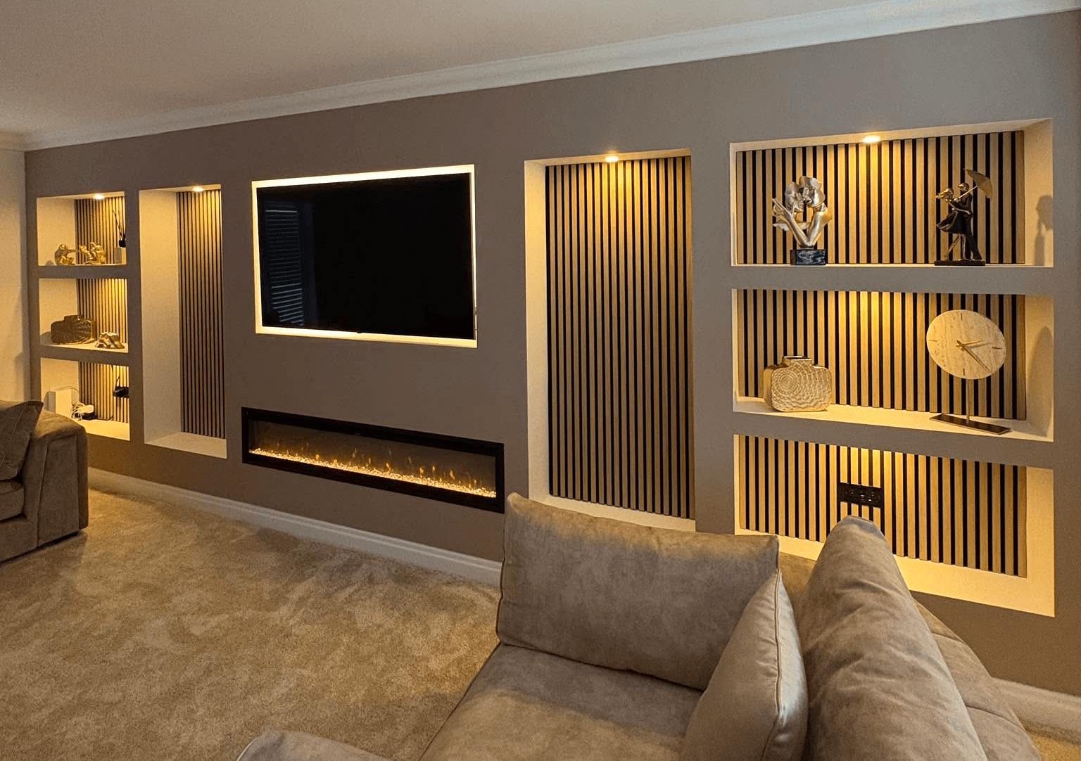 Luxury bespoke media wall with fireplace, shelving and acoustic panelling